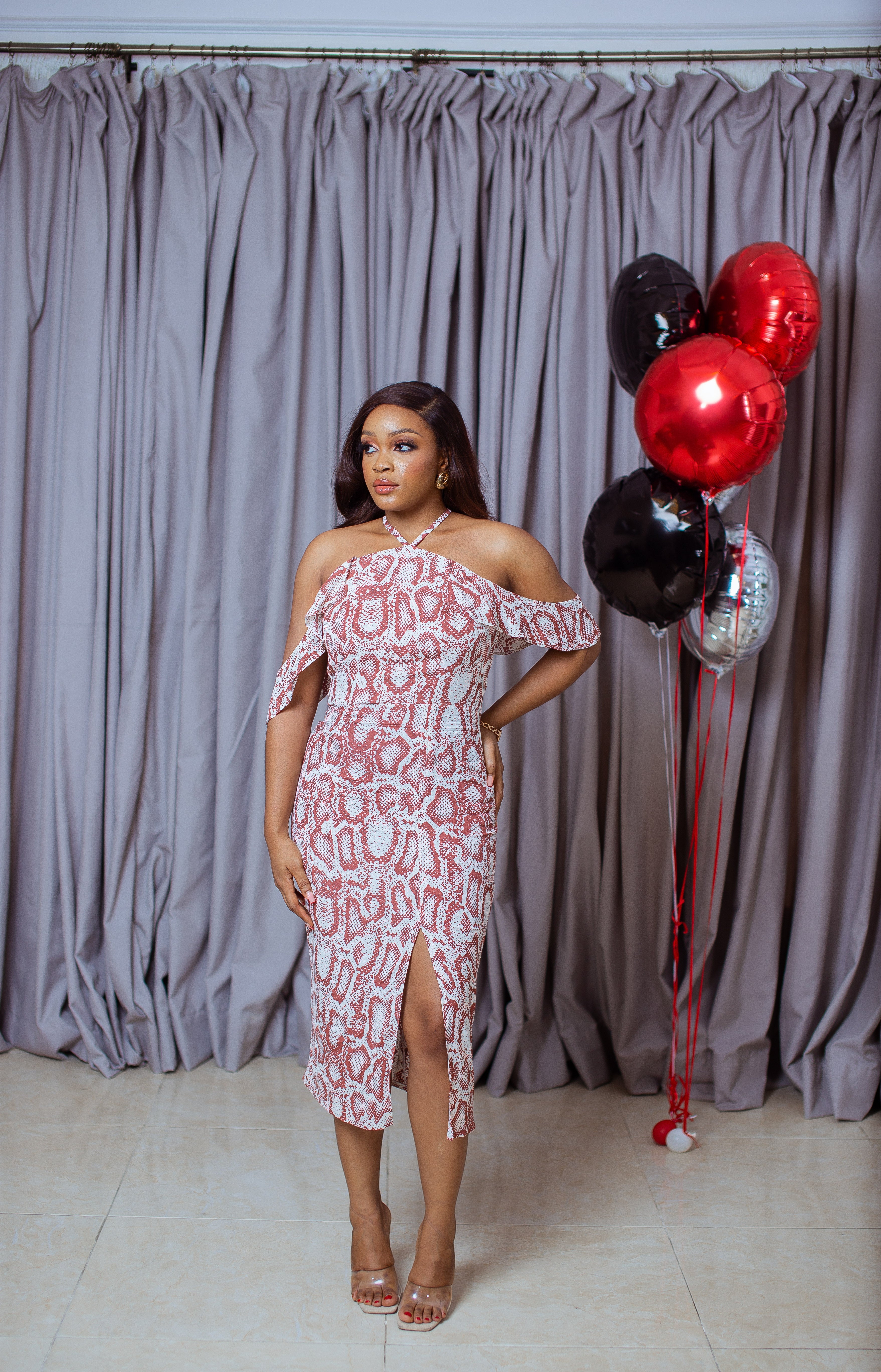 Animal silky print diamond neck line with front slit on a midi pencil dress